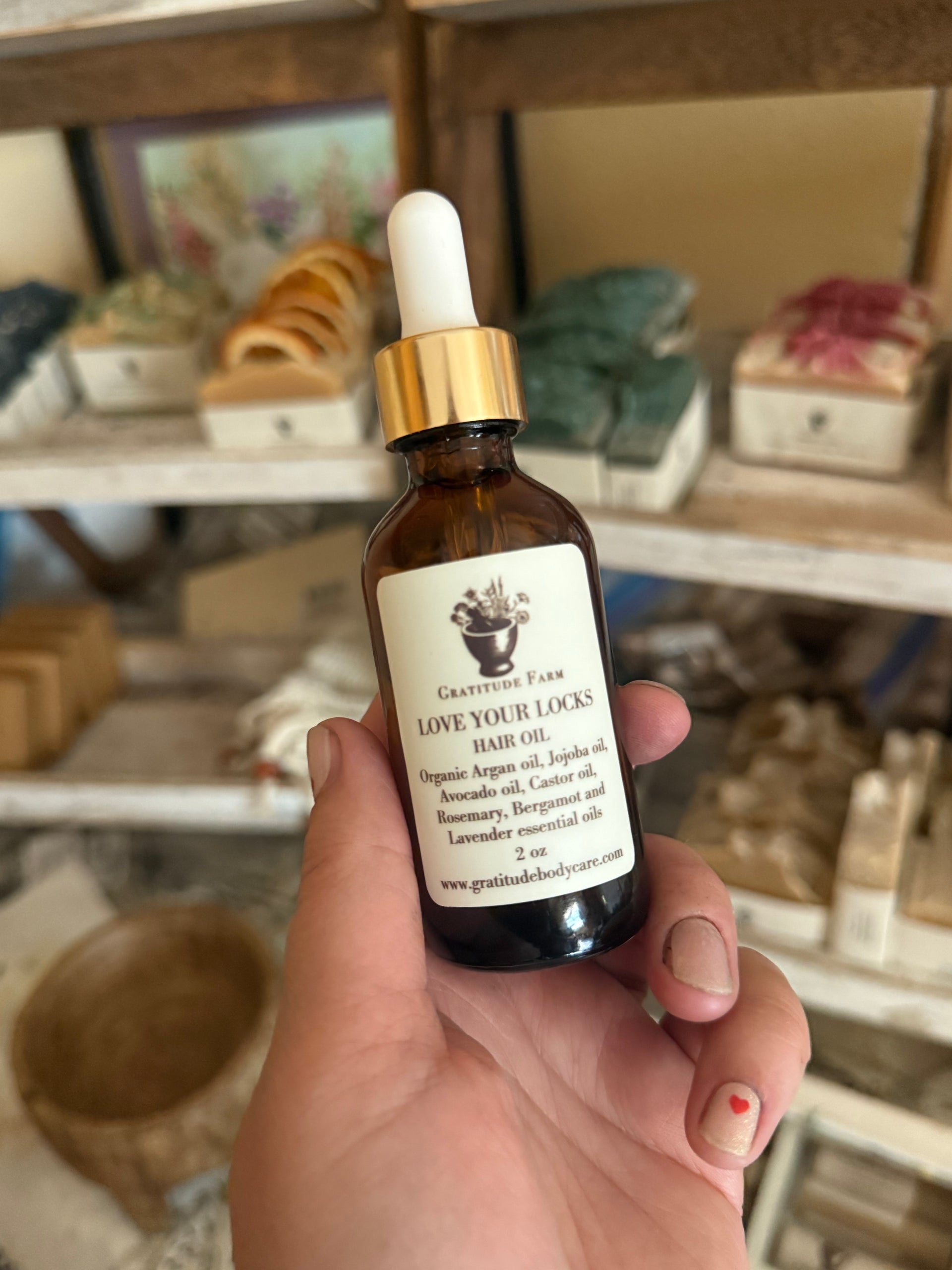 dark glass dropper bottle with argan oil and essential oils like rosemary and lavender